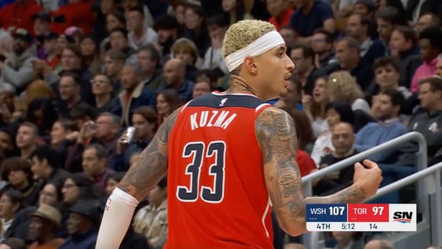 Kyle Kuzma talks to the Wizards bench